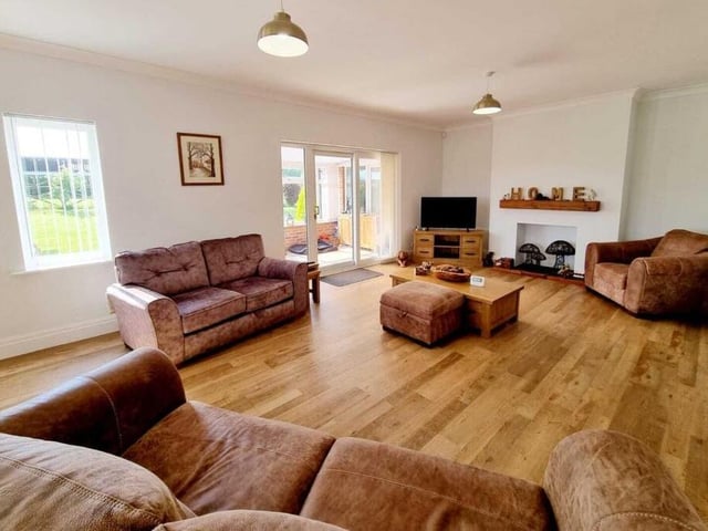 A large living room attracts plenty of natural light.