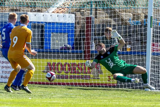 Whitby Town keeper Shane Bland makes a save against Hartlepool. Photo by Brian Murfield