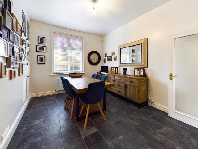 The dining room has built-in cupboards to one wall.
