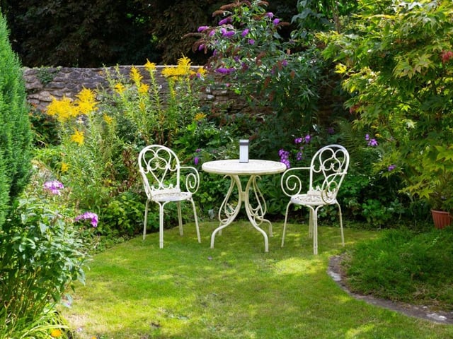 The grounds include a south-facing rear garden and a 'secret garden' with a door to the walkway along Thornton Beck.
