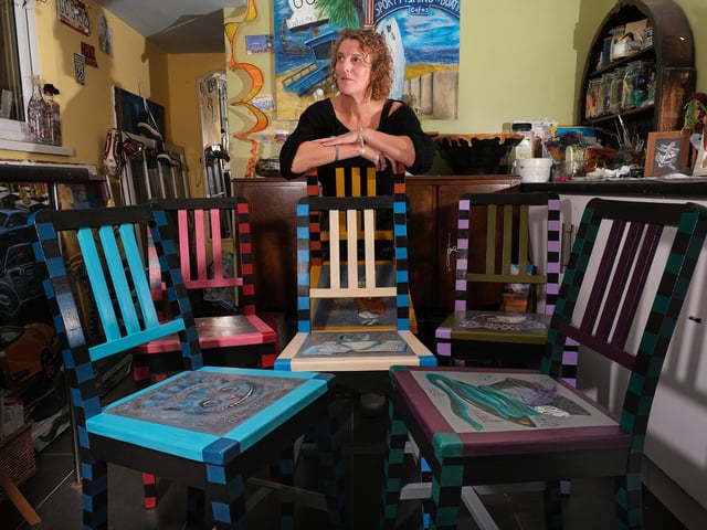 Artist Helen Randle with her Alice in Wonderland themed chairs