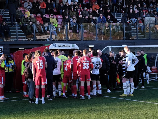 The two sets of players leave the field at the start of the 38-minute suspension.