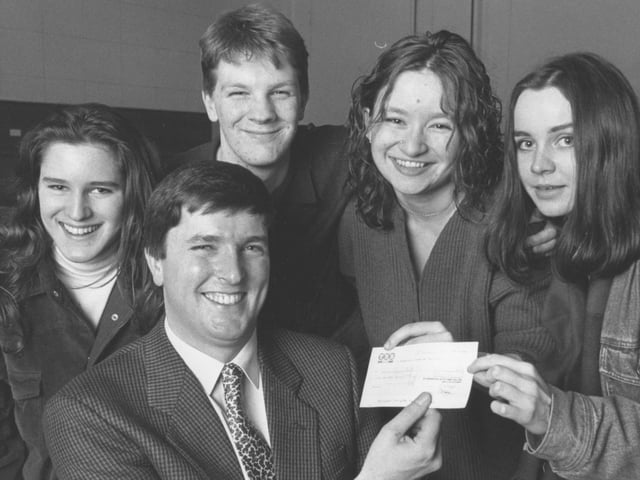 Terence Higgins Trust speaker Max Potter, front, received a £300 cheque from four members of the Sixth Form College Charities Committee Group in January, 1993. From left, Cheryl Binnis, Martin Bradnam, Eliza Carthy and Liz Williams.