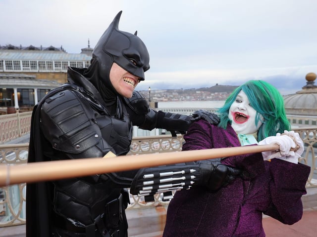 Batman apprehends The Joker.