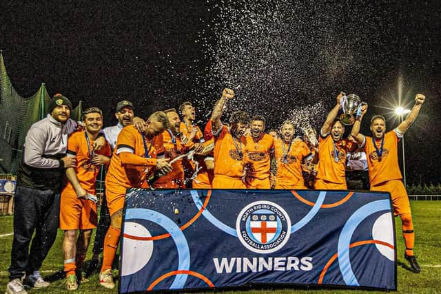 Edgehill, pictured celebrating the NRCFA Challenge Cup, won the ER County League Championship North title on Saturday. Photo by Karen Harland Photography