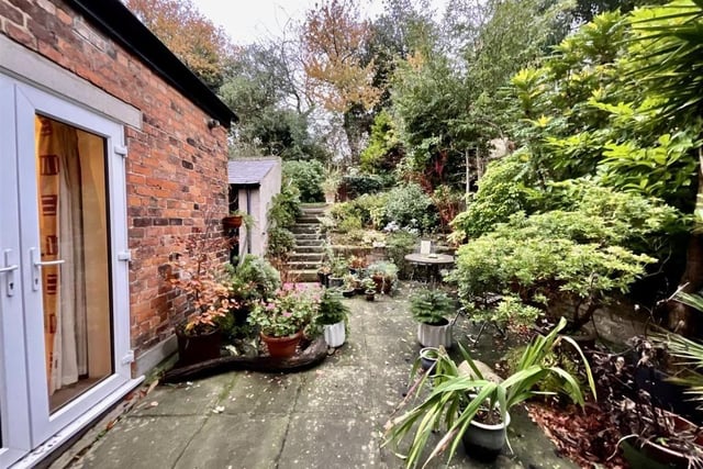 A sheltered seating area at the back of the house gives access to the lawned garden.