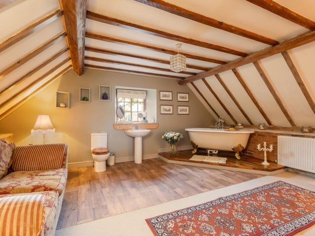 A distinctive bathroom with free-standing bath within its suite.