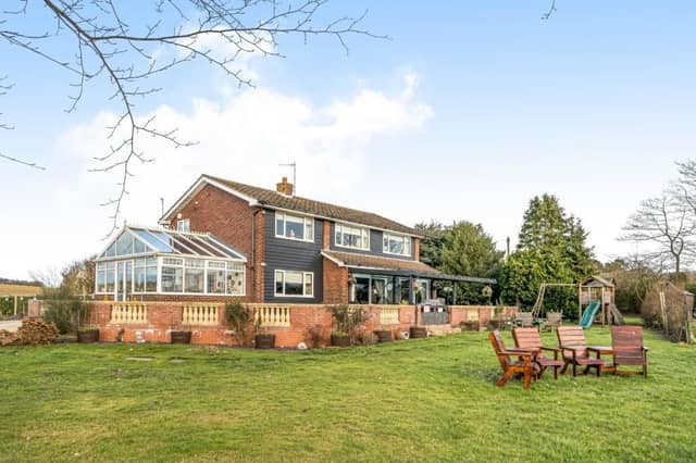 The house has south facing gardens with lawns and a walled patio area.