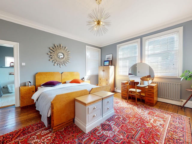 This sizeable double bedroom with large windows has its own en suite facility.