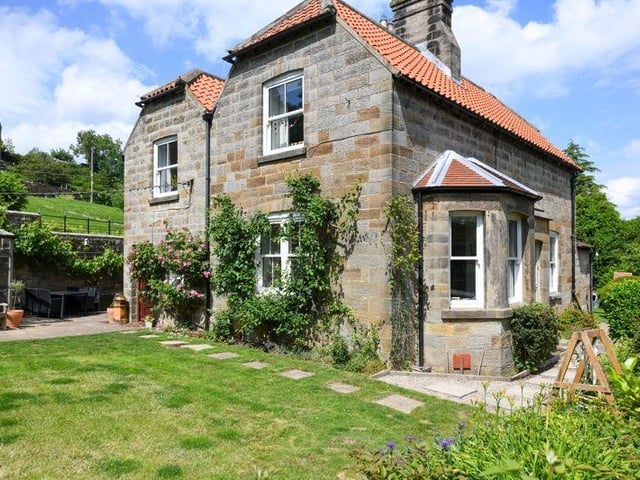 A gorgeous garden with wall-climbing plants making the house look even more lush.