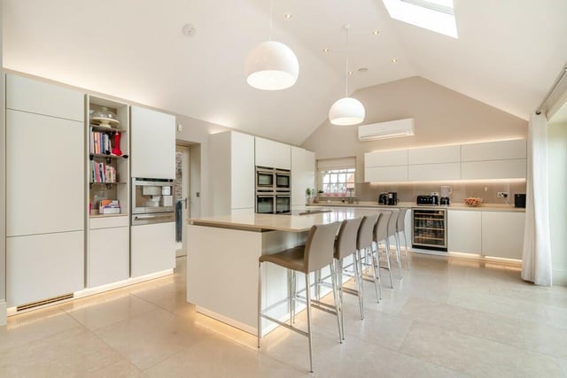 The open plan kitchen is high spec and spacious, with a central island.