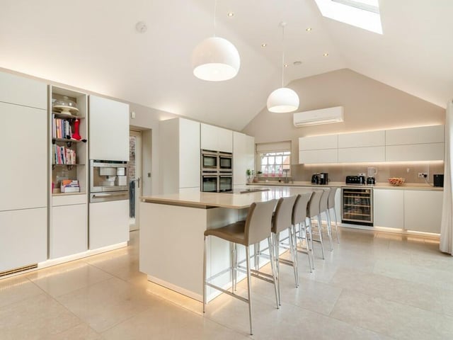 The open plan kitchen is high spec and spacious, with a central island.
