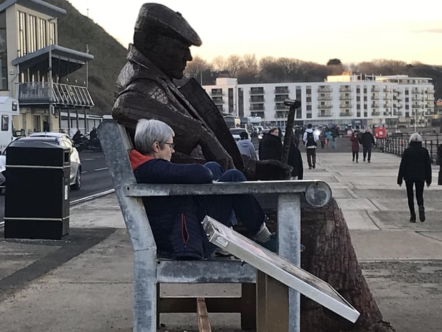 Relaxing on the bench at North Bay with Freddie Gilroy, by John Savage.