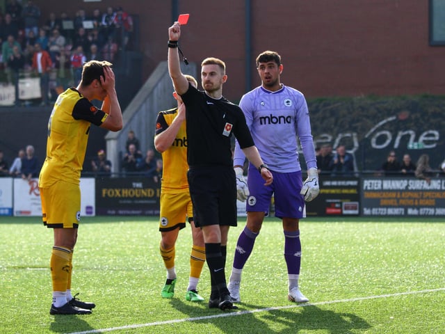 Harrison Burke holds his head in disbelief after being sent off in injury-time.