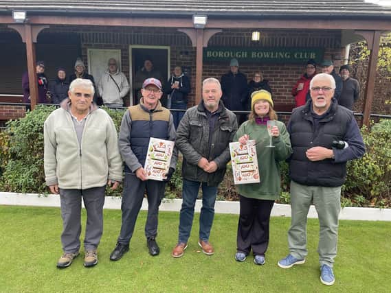 Borough Bowling Club President Steve Taylor handing out selection boxes to the Winter Merit finalists with other competitors looking on