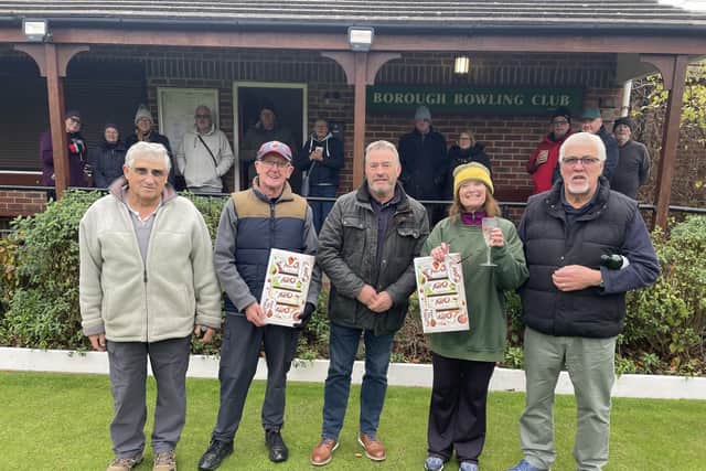 Borough Bowling Club President Steve Taylor handing out selection boxes to the Winter Merit finalists with other competitors looking on