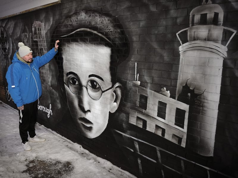 Artist Rew Nurse with his mural.