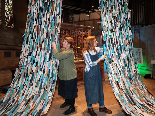 Petra Ingham and daughter Liberty add the finishing touches to the installation