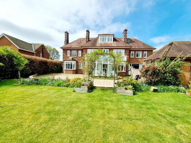 The stunning rear view of the property, as seen from its extensive lawned garden, that is south-facing.
