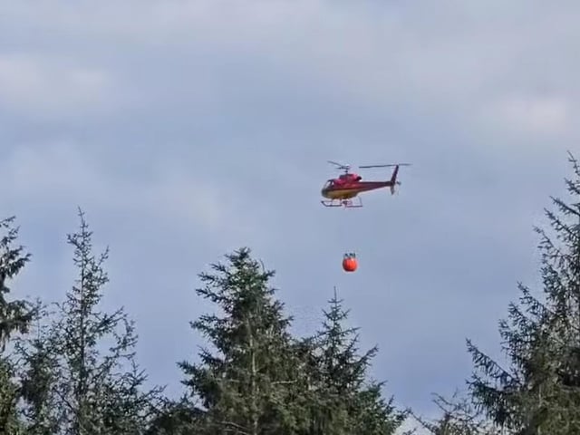 Helicopter drop water on the blaze.