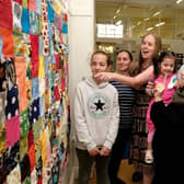 Visitors admire the "Stitch Together Quilt"