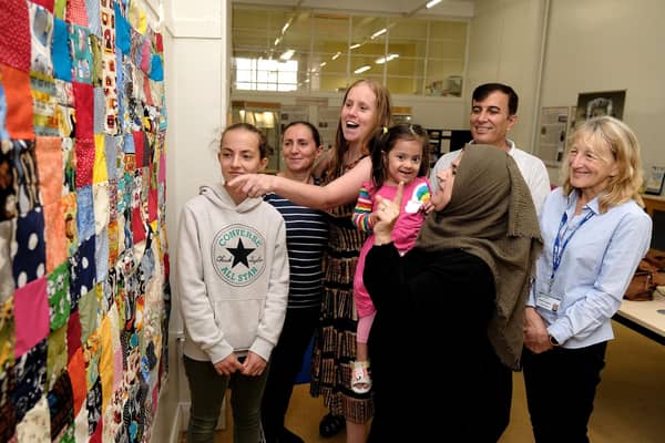 Visitors admire the "Stitch Together Quilt"