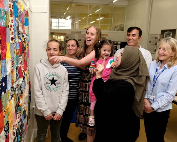 Visitors admire the "Stitch Together Quilt"