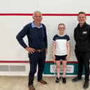 Chris West, left, and Ollie West, of West Building Supplies, right, have become one of the main sponsors of Bridlington squash star Hattie Langley, centre.