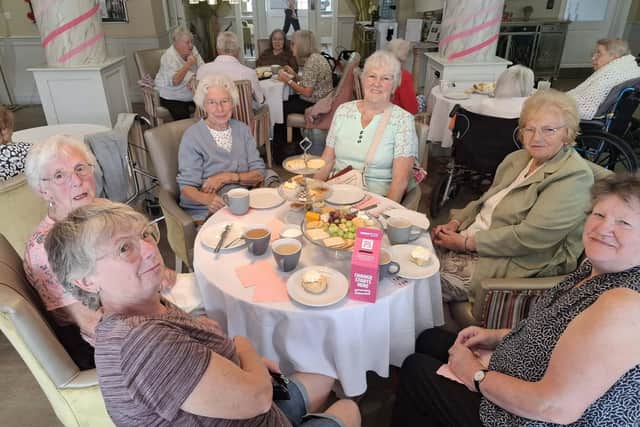 Relatives and residents enjoy the Pretty in Pink Afternoon Tea.