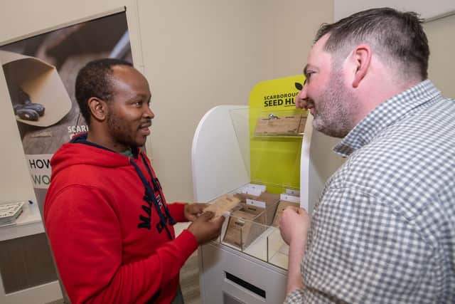 The founder and chairman of GROW Scarborough, Darren Mancrief (right), promoting the seed hub project to visitors at Scarborough Library.