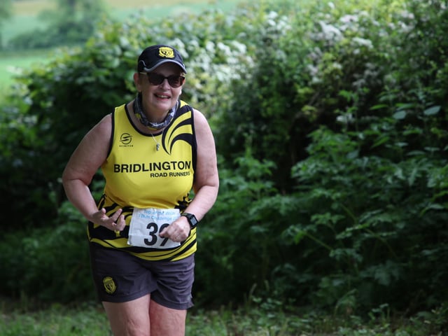 A Bridlington Road Runners is all smiles at the Top of the Wolds 10K Challenge.