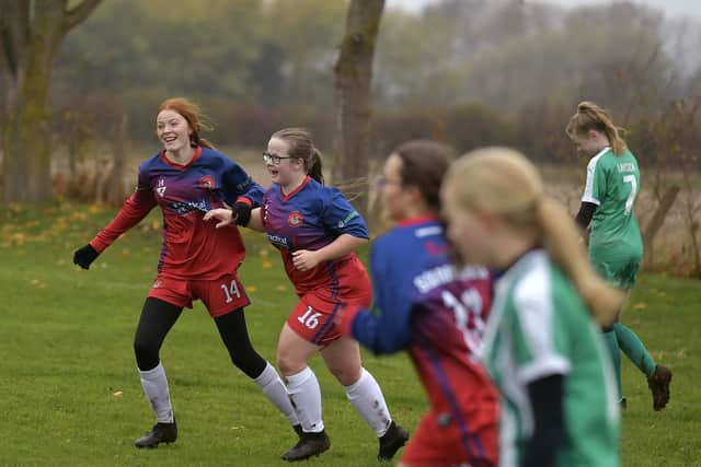 Ellie-Mae Bloomfield, no 16, celebrates her goal with Sarah Dicks, no 14