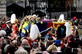 The Queen's coffin passes along Whitehall