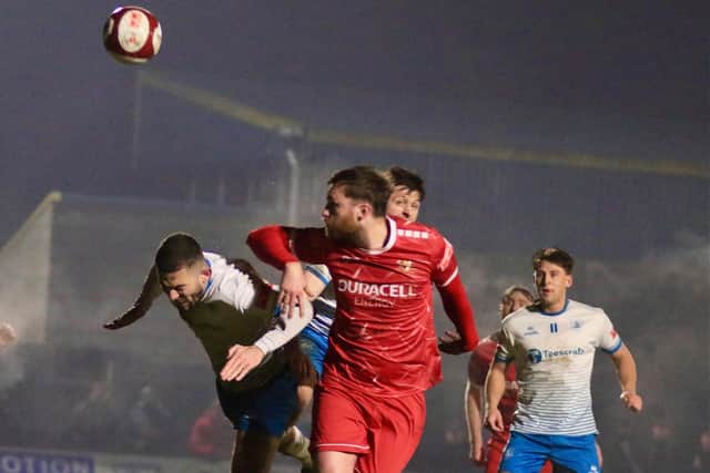 Tom Allan heads Brid Town 3-2 ahead against Bishop Auckland. Photo by Alexander Fynn