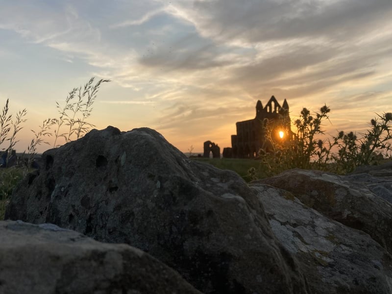 Sun setting through 'window' of Whitby Abbey, by Emma Thornsby.