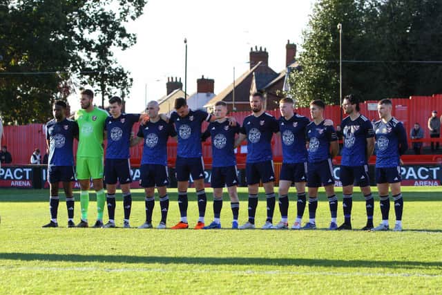 Athletic players observe two minutes' silence before the game at Alfreton Town.