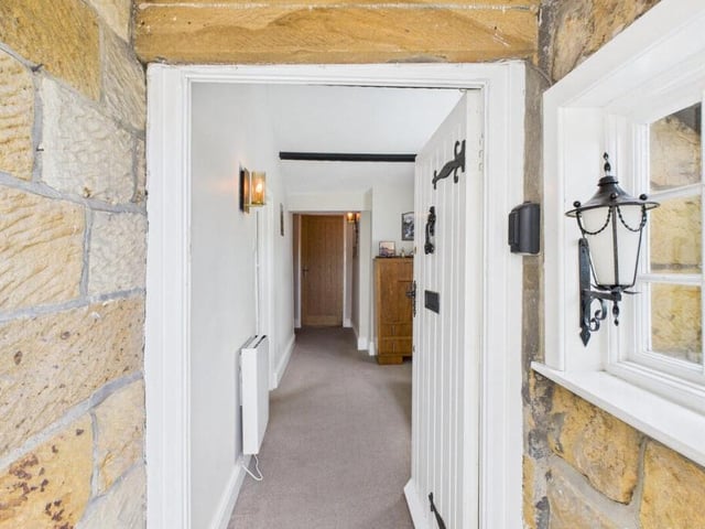 Stone walls and wooden doors feature inside the home.