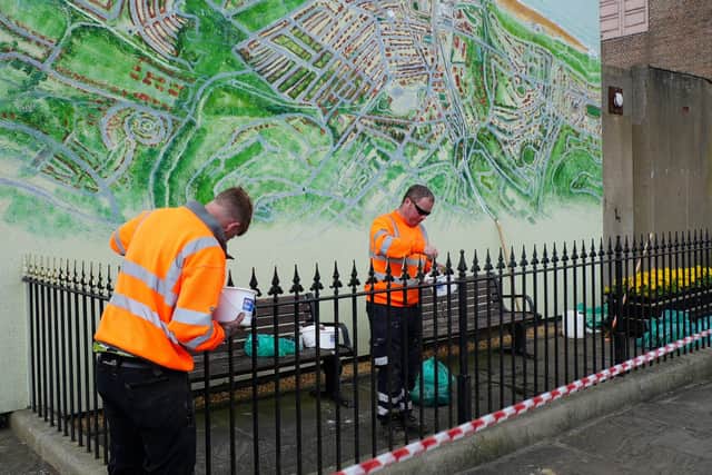 Council employees paint railings as part of the Scarborough improvement scheme.