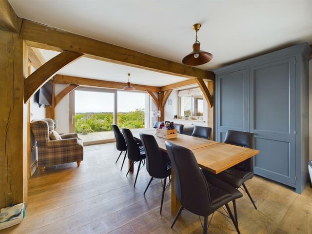 The dining area has doors leading outside to the patio and garden.
