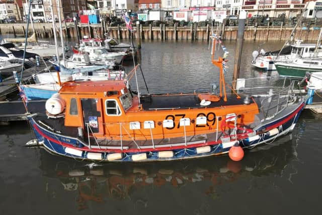 A close-up of the retired lifeboat that has a bedroom, bathroom and kitchen.