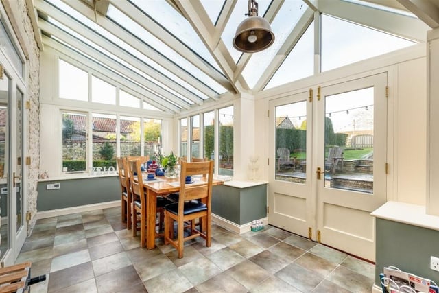 The garden room opens out to the patio and lawned garden.