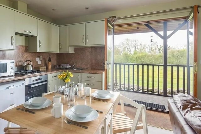 A dining kitchen opens to a balcony in one of the double glazed lodges.