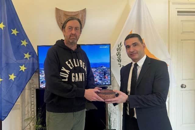 PC Bradley Hay handing over one of the items at the High Commission of Cyprus