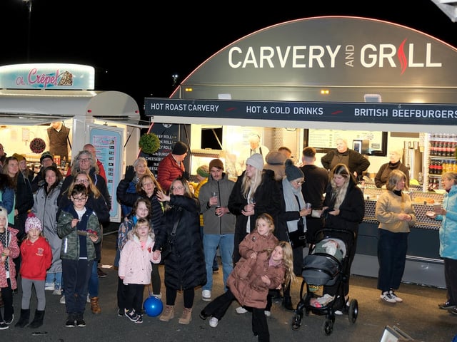 Families and shoppers enjoying the night.