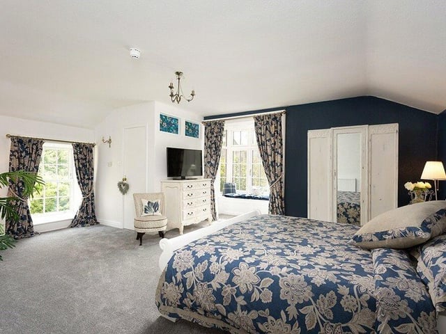 Another stunning bedroom, with a window seat.