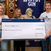 From left: Jess Slater, Jo White and Luke Pentith at Whitby Distillery in Botany Way, and the £5,000 cheque for Yorkshire Wildlife Trust.