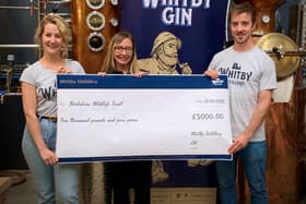 From left: Jess Slater, Jo White and Luke Pentith at Whitby Distillery in Botany Way, and the £5,000 cheque for Yorkshire Wildlife Trust.