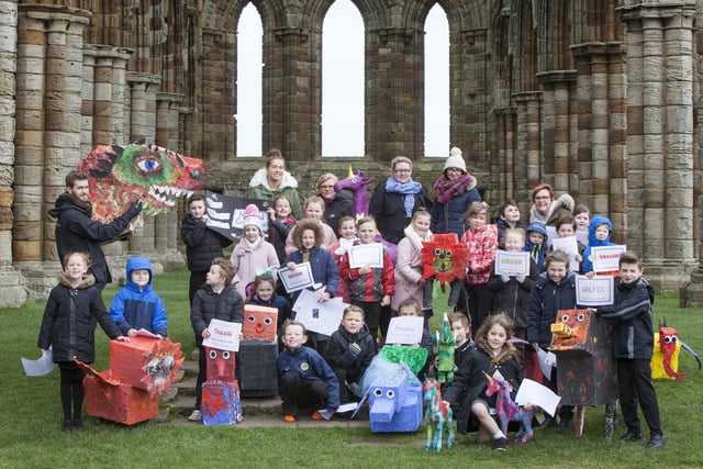 East Whitby Academy pupils are pictured with their magical creature creations at Whitby Abbey.