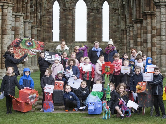 East Whitby Academy pupils are pictured with their magical creature creations at Whitby Abbey.