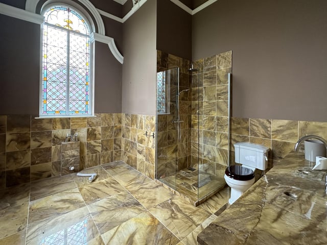 One of the luxurious marble en suite bathrooms to six bedrooms.